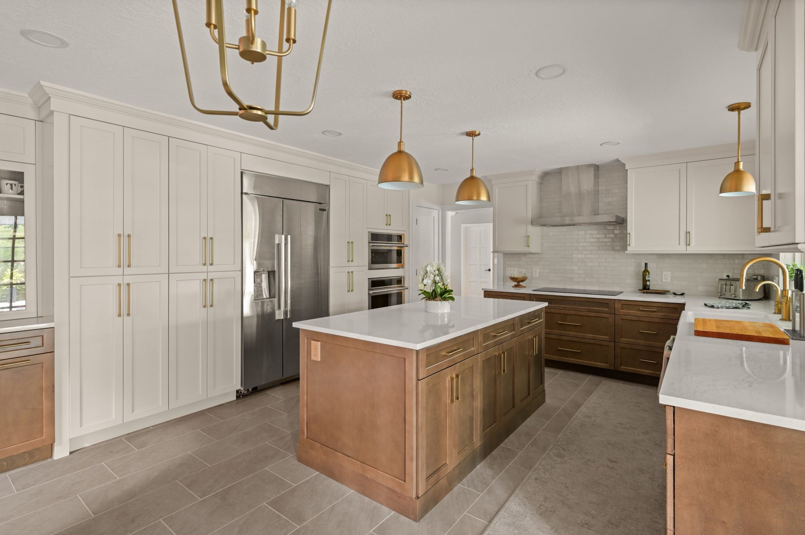 Longwood kitchen remodel wood cabinet island, with bronze lighting